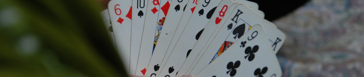 person holding fan of playing cards