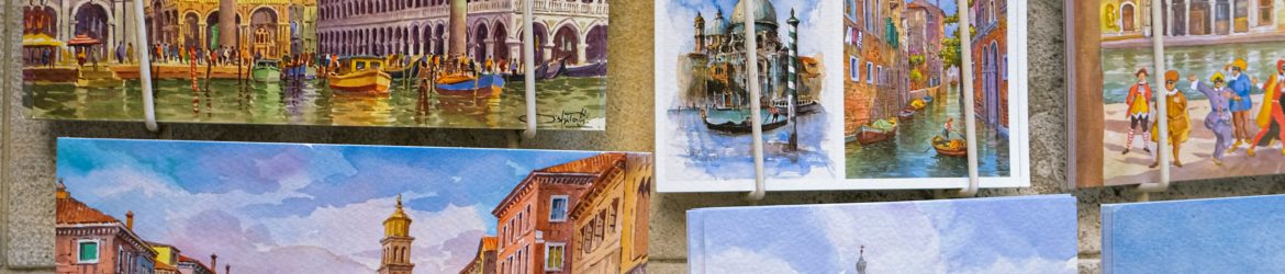 a bunch of paintings are hanging on a wall