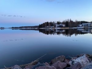 a body of water with buildings and trees around it