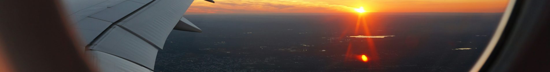 airplanes window view of sky during golden hour